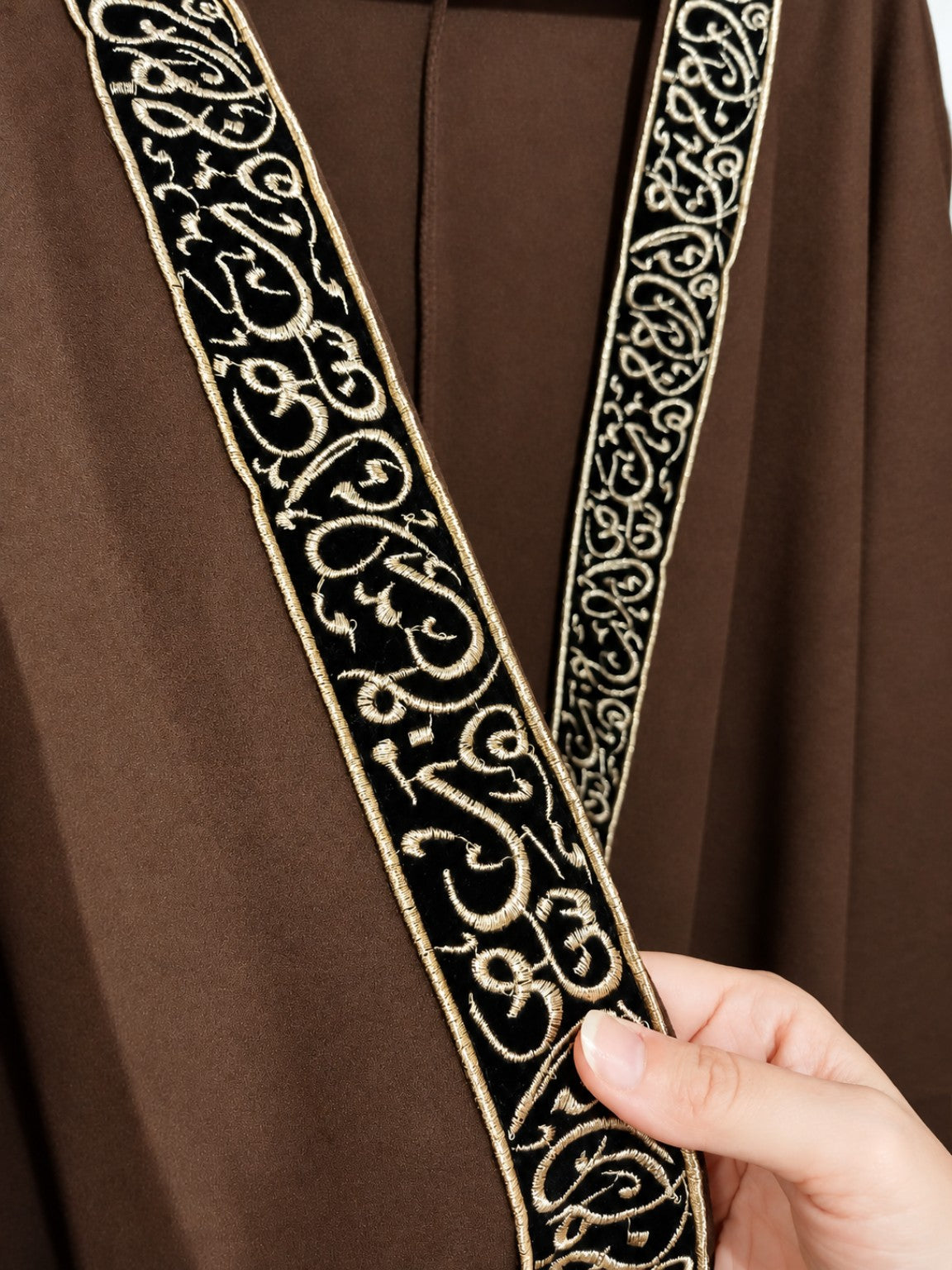 Brown cape decorative trim detail